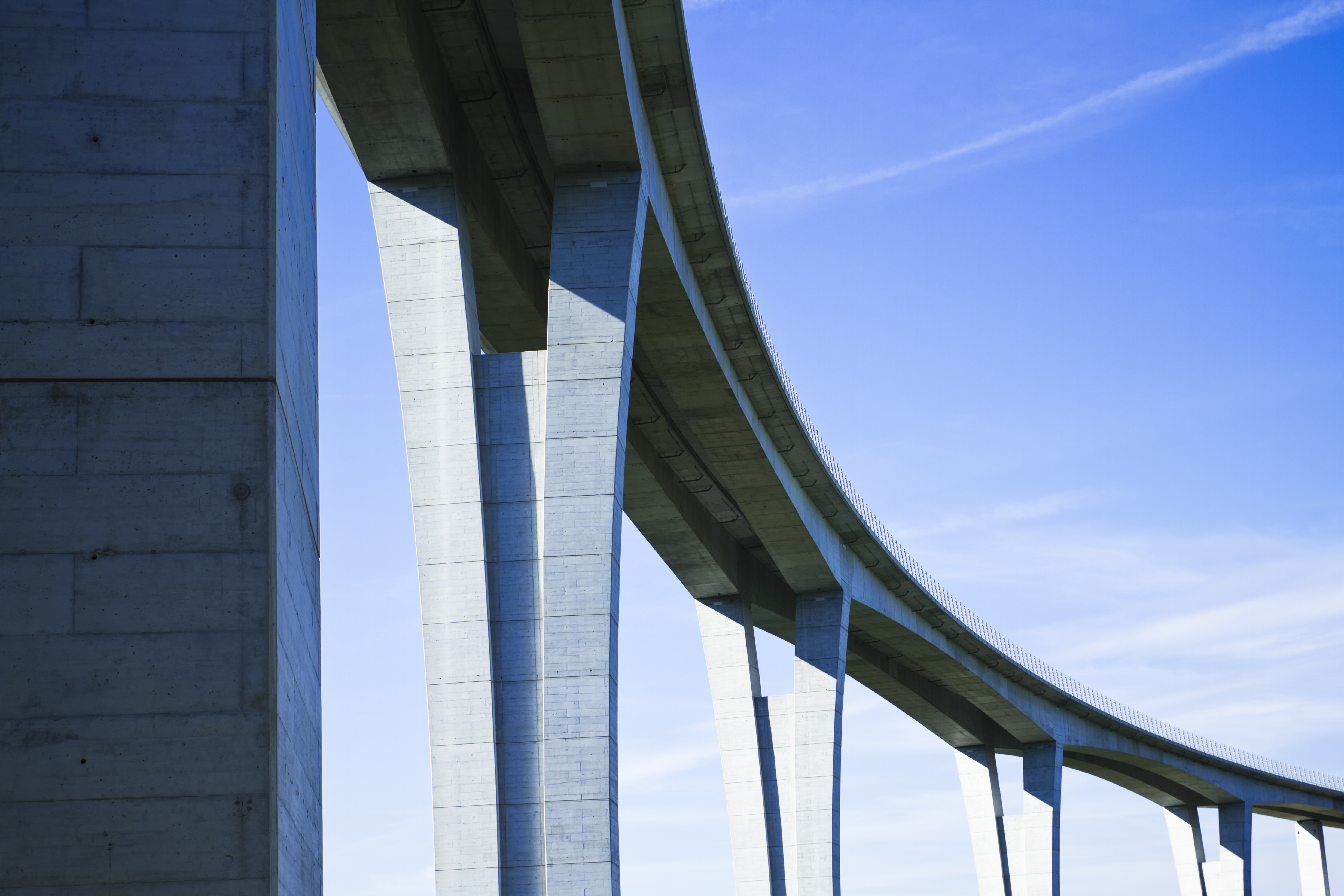 Close up of highway viaduct in front of a clear blue sky
